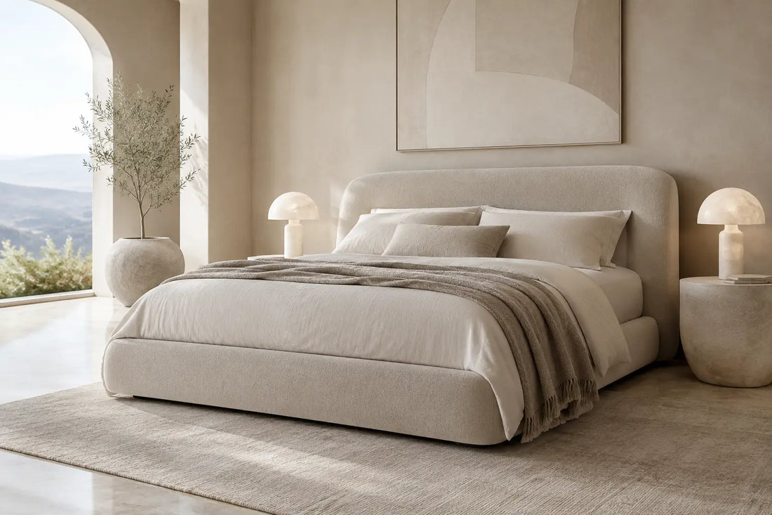 Upholstered bed in a serene plaster bedroom with alabaster lamps