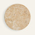 The Alba travertine wall light, a flat round stone disc