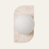 The Bolla travertine wall light, an opal glass globe on a stone plate