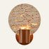 The Calice travertine wall light, a round stone disc with a walnut cup
