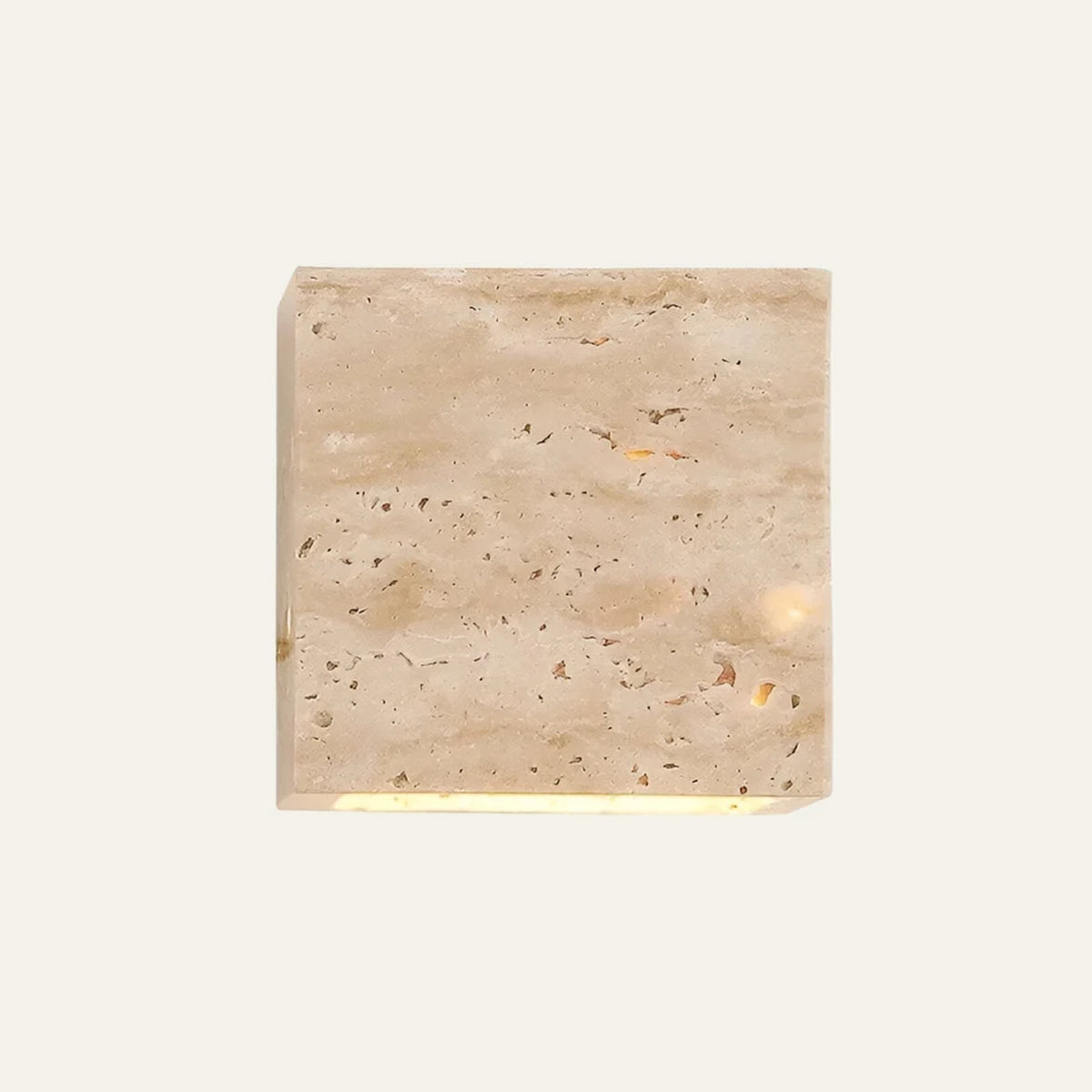 The Cubo travertine wall light, a solid stone cube, indoor version