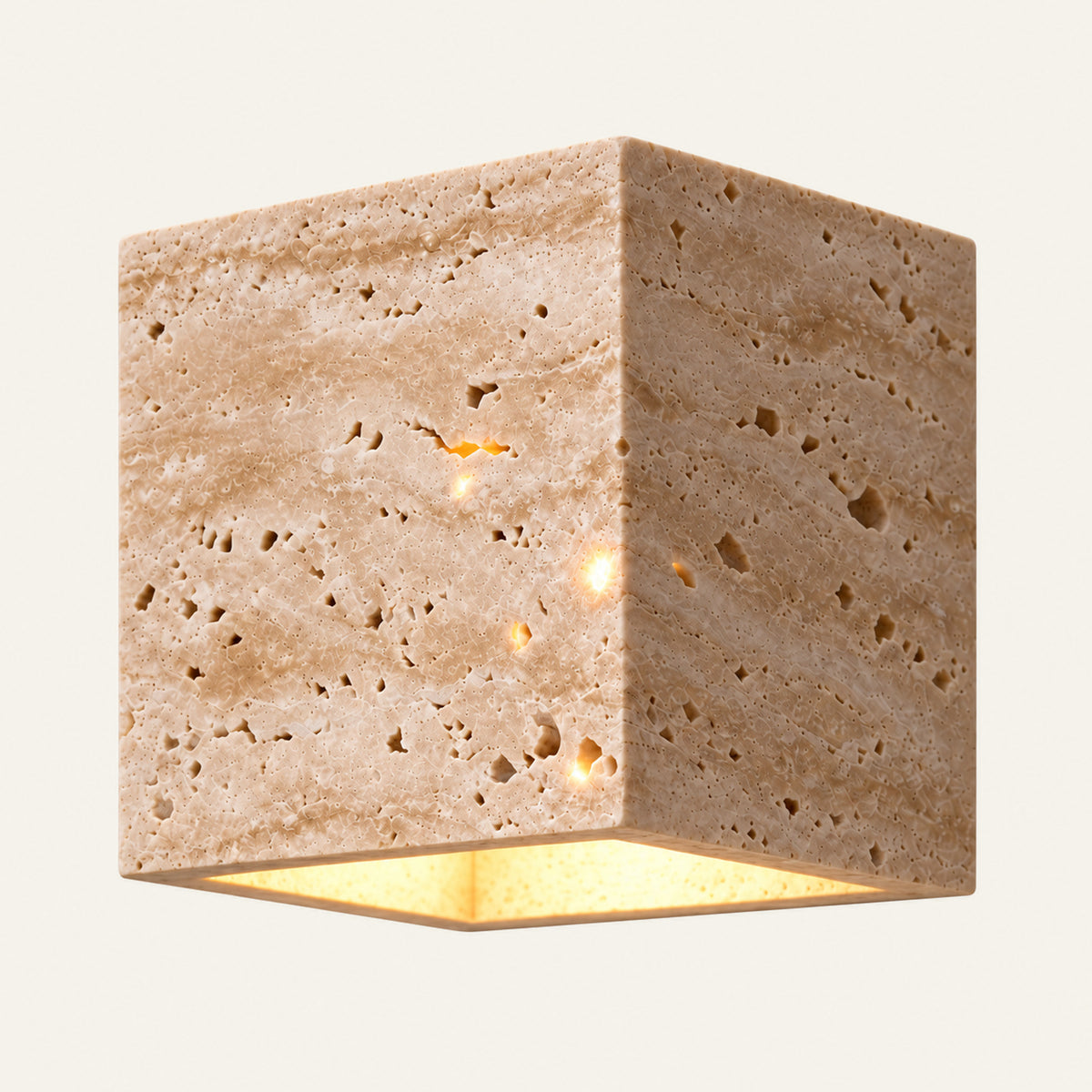 The Cubo travertine wall light, a solid stone cube