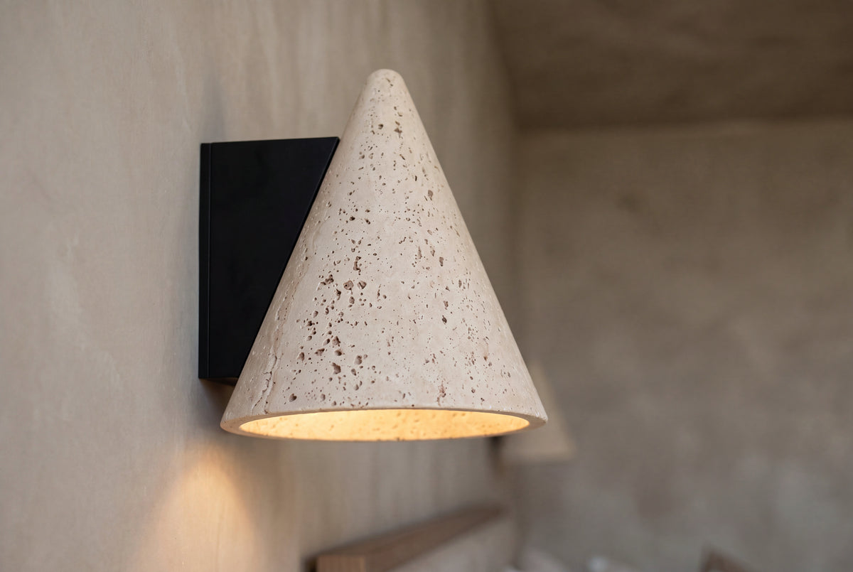The Cuspide Travertine Wall Light, lifestyle close-up