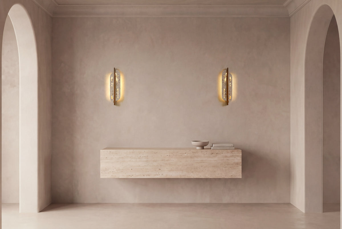 The Foglia Travertine Wall Light, a pair above a floating travertine console