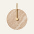 The Gancio travertine wall light, a round stone disc with a curved brass arm