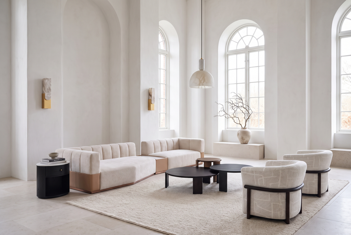 Gallery White, a white modular sofa and black tables in a lofty room with tall arched windows