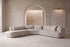 The Amalfi Curved Corner Sofa in cream boucle with matching cushions in a grand arched plaster living room