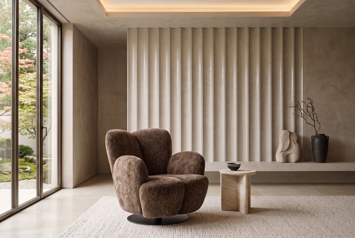 The Ancona Swivel Chair in chocolate brown in a warm plaster room