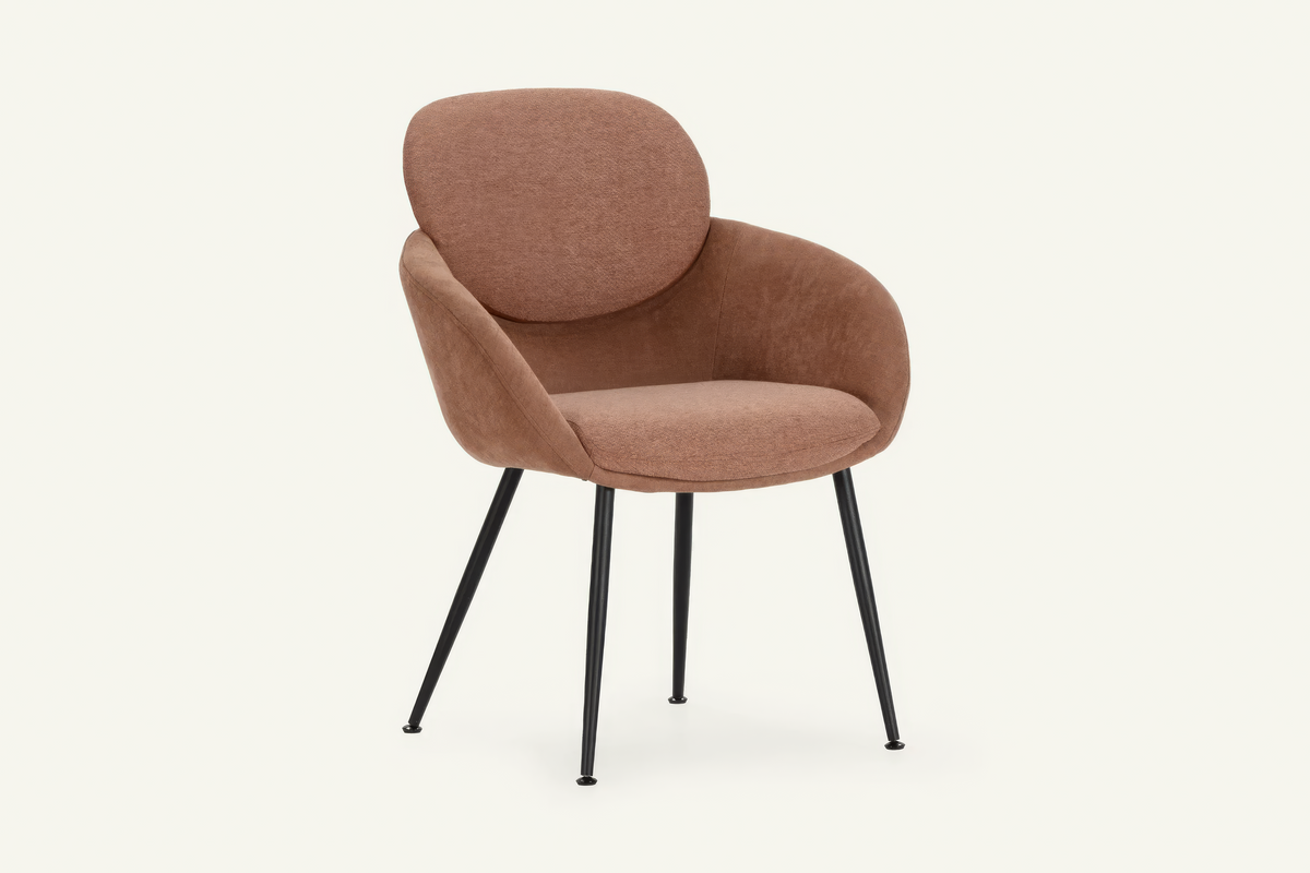 The Arona Armchair in coral, upholstered tub armchair on slim black legs, studio view