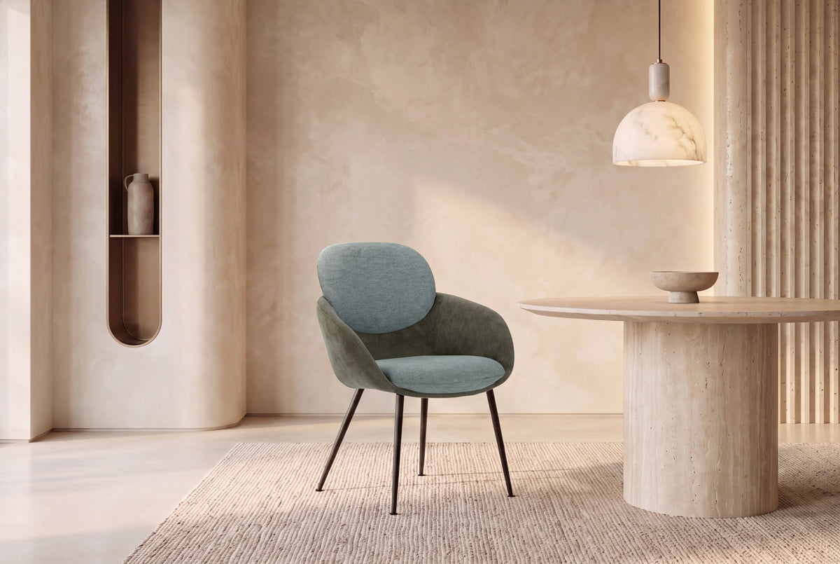 The Arona Armchair in forest green, upholstered tub armchair on slim black legs, styled in a room