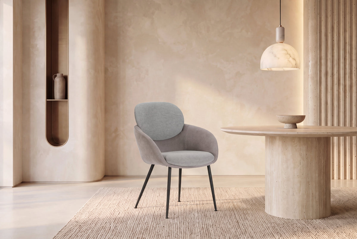 The Arona Armchair in grey, upholstered tub armchair on slim black legs, styled in a room
