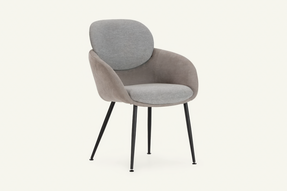 The Arona Armchair in grey, upholstered tub armchair on slim black legs, studio view