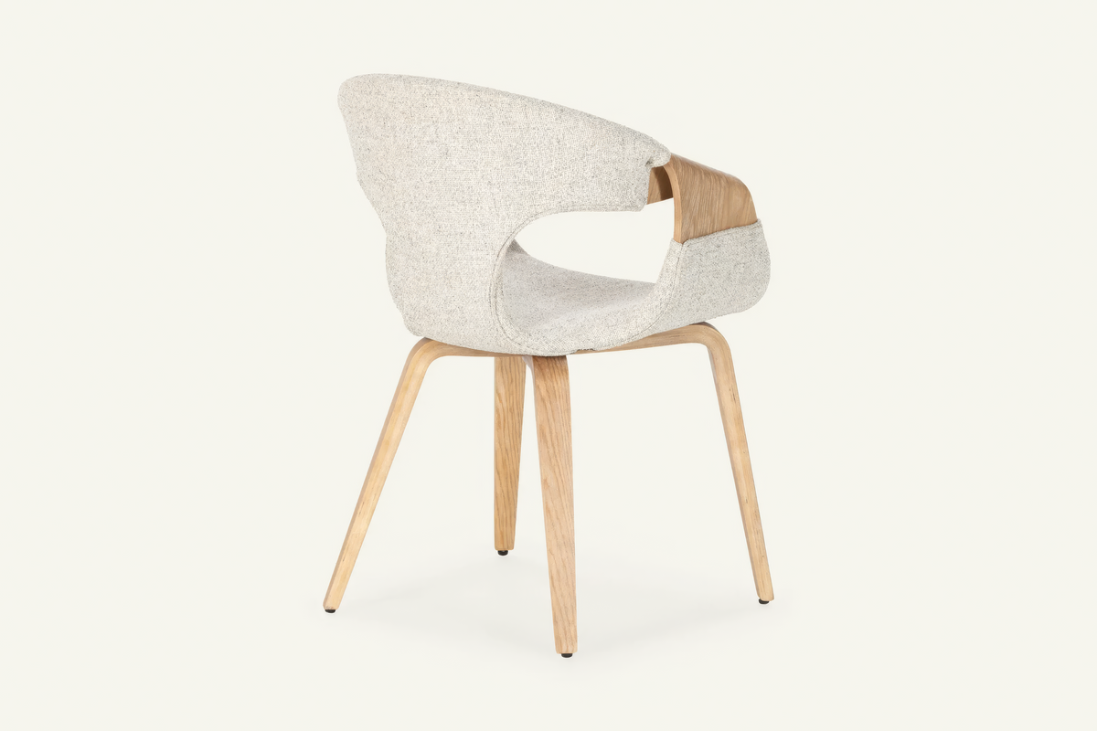 The Ascoli Dining Chair, ivory dining chair with an open curved oak back, studio view