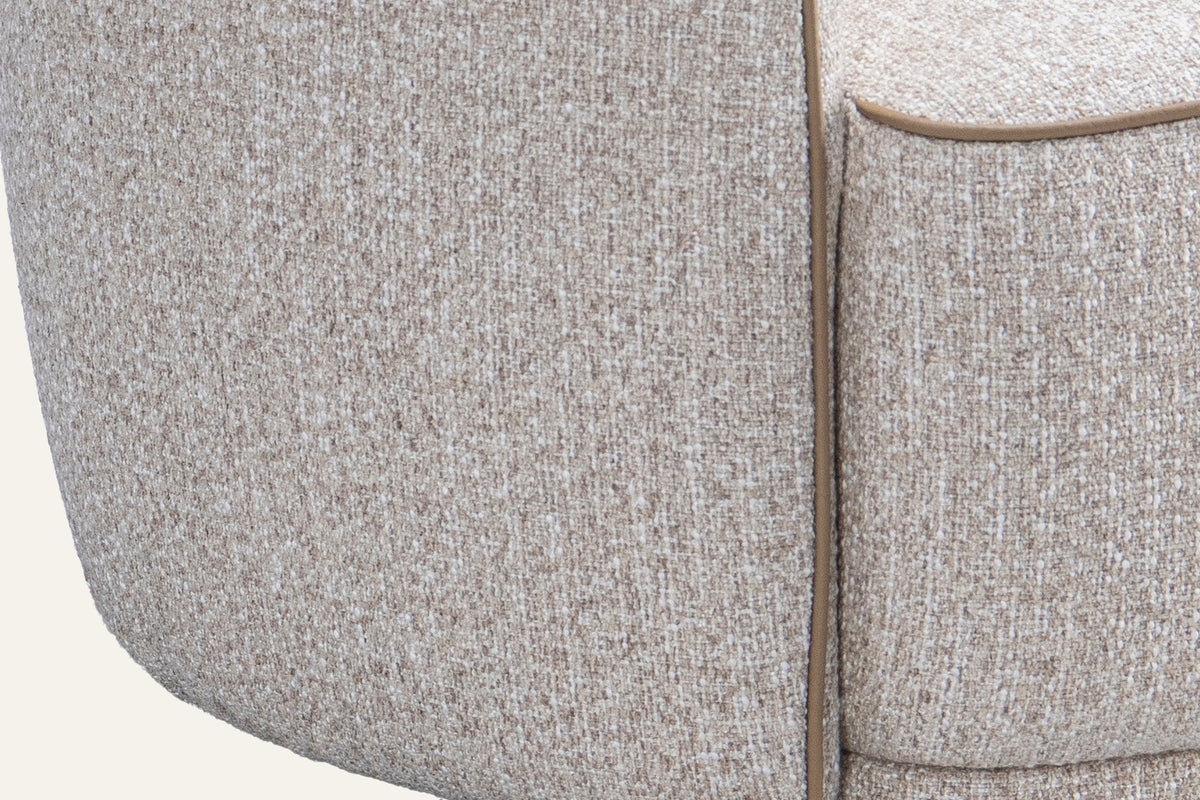 The Asolo Tub Chair, close-up of the rounded arm and contrast piping