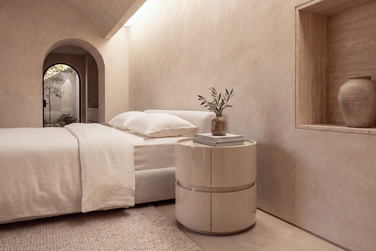 The Bellano Bedside Table in gloss beige beside the Positano bed in a barrel-vaulted plaster bedroom