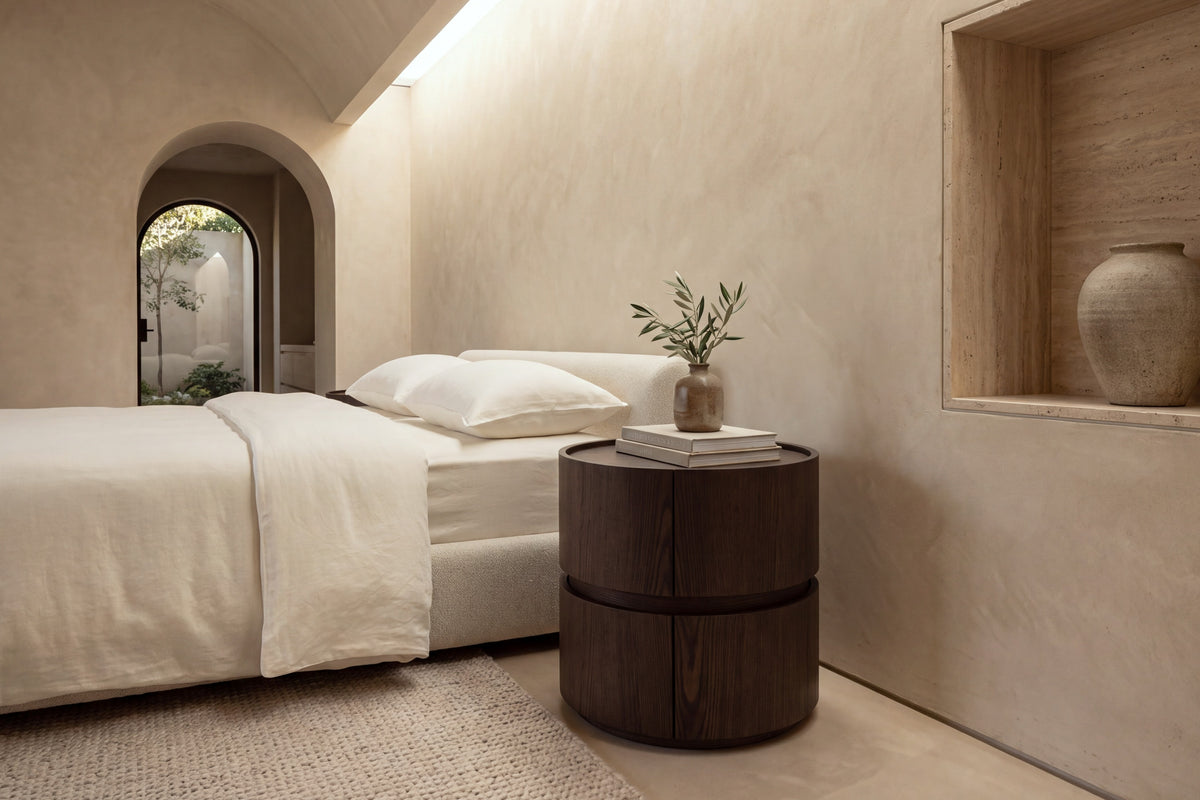 The Bellano Bedside Table in walnut beside the Positano bed in a barrel-vaulted plaster bedroom