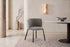 The Bormio Dining Armchair in grey, upholstered dining armchair on black metal legs, styled in a room