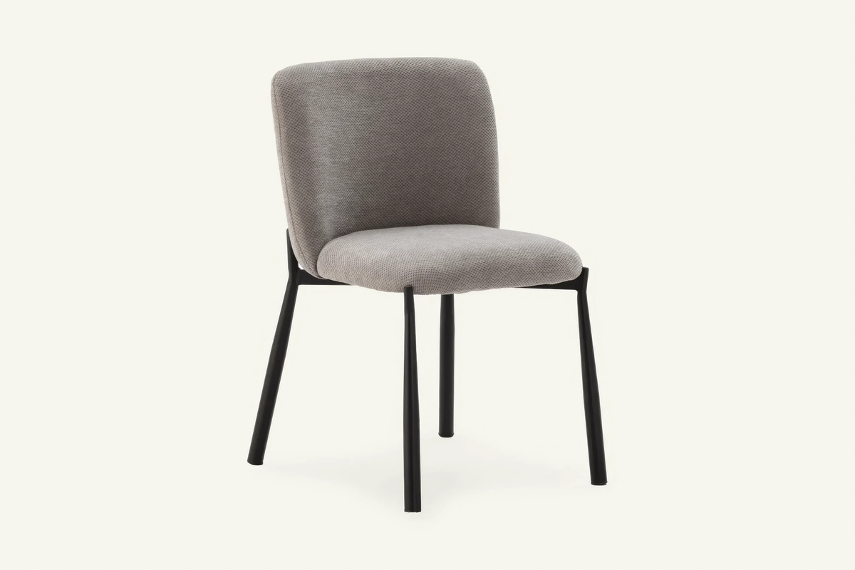 The Bormio Dining Chair in grey, upholstered dining chair on black metal legs, studio view
