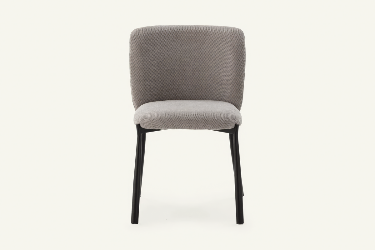The Bormio Dining Chair in grey, upholstered dining chair on black metal legs, studio view
