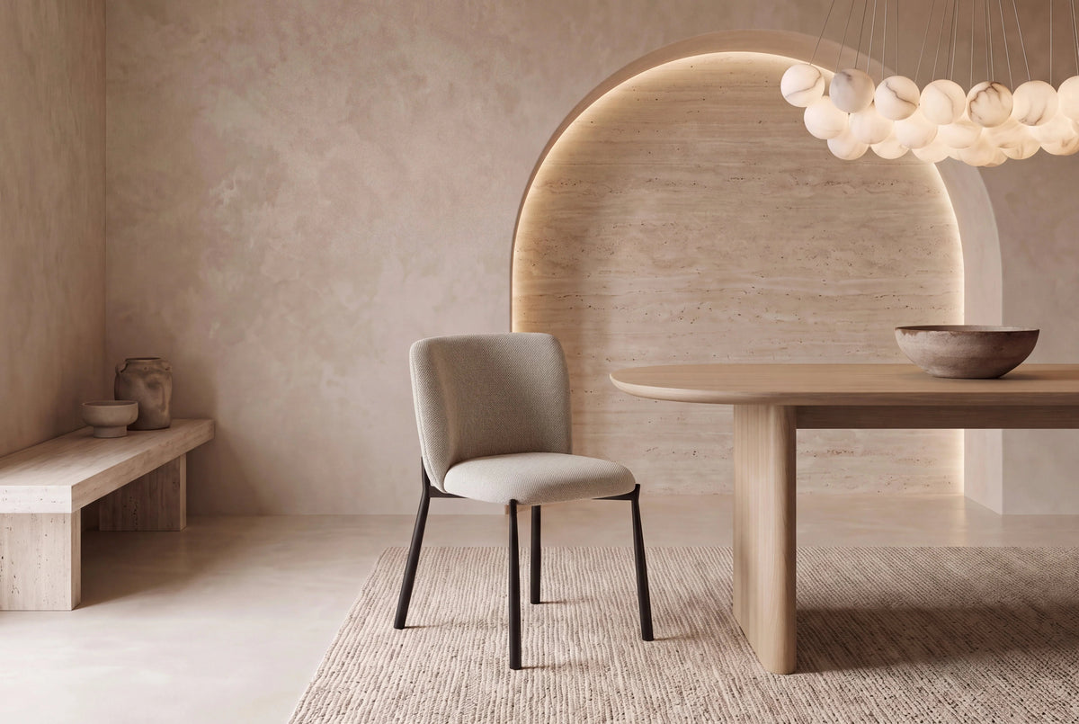 The Bormio Dining Chair in oatmeal, upholstered dining chair on black metal legs, styled in a room