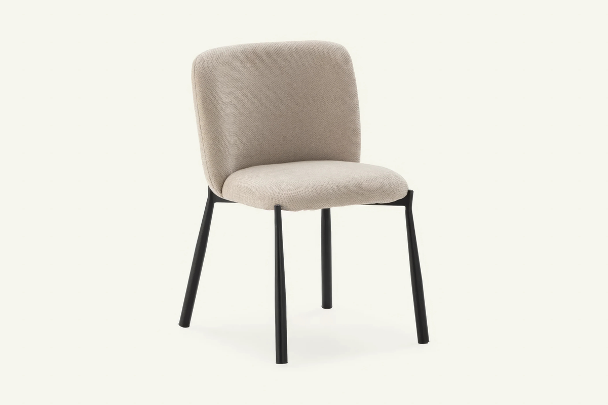 The Bormio Dining Chair in oatmeal, upholstered dining chair on black metal legs, studio view