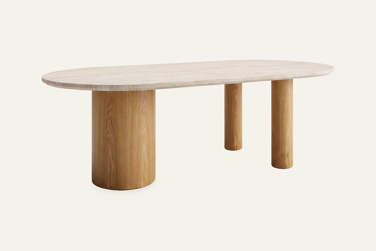The Bracciano Oval Dining Table in cream, cream quartz oval dining table on ash pillar legs, studio view