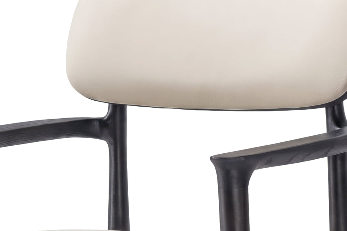 The Brindisi Dining Armchair, close-up of the ivory back and black frame