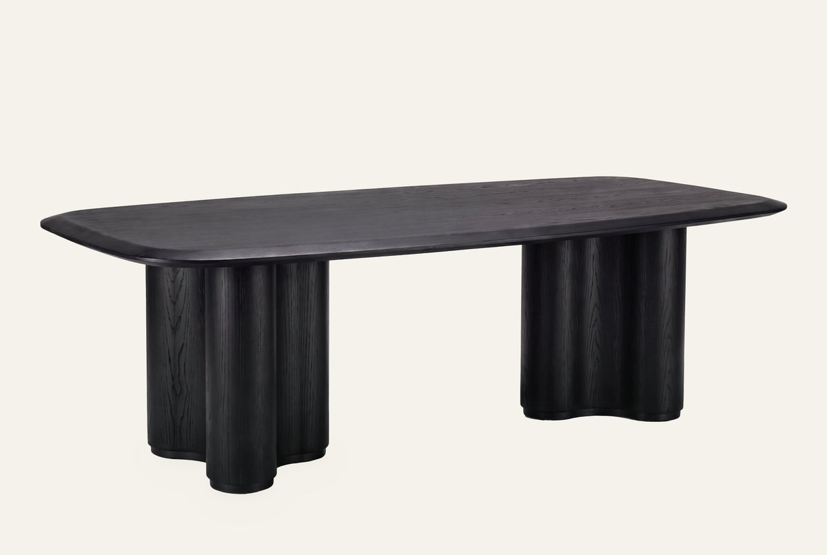 The Brindisi Dining Table in black oak, studio view