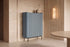 The Camogli Fluted Highboard in blue against a travertine wall beside an alabaster wall light