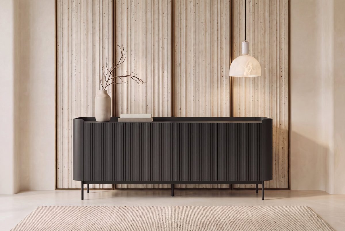 The Camogli Fluted Sideboard in black, fluted sideboard with rounded ends, styled in a room