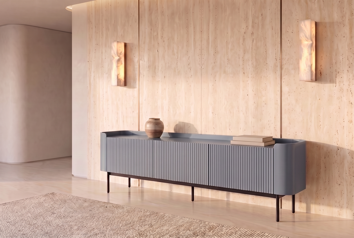 The Camogli Fluted TV Unit in blue against a travertine wall between two alabaster wall lights