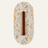 The Capsula travertine wall light, a tall rounded stone capsule with a vertical wooden bar and a soft halo of light