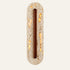 The Navetta travertine wall light, a slim stone capsule with a long vertical wooden bar