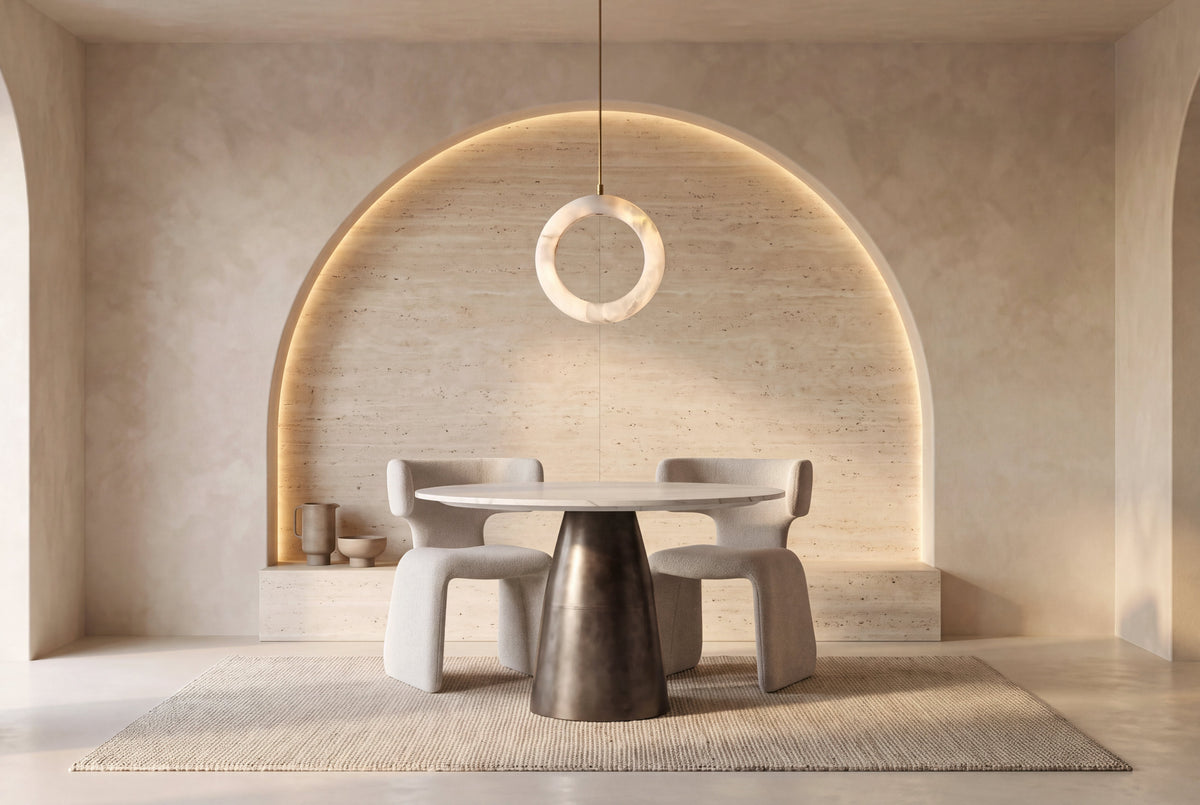 The Carrara Marble Round Dining Table, round white marble dining table on a dark pedestal, styled in a room