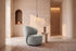 The Erice Accent Chair, tall rounded grey accent chair, styled in a room
