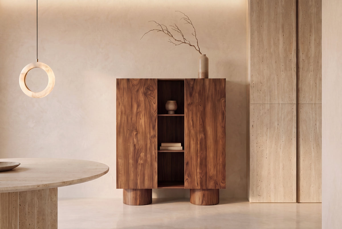 The Faenza Highboard in walnut beside a travertine dining table beneath an alabaster ring pendant