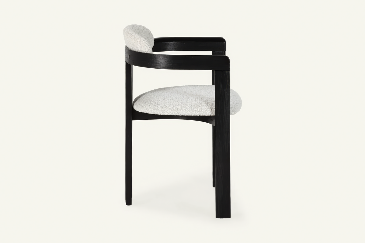 The Garda Dining Armchair, dining armchair with an ivory boucle seat on a black frame, studio view
