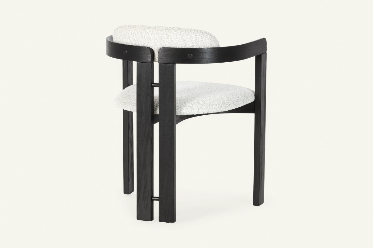 The Garda Dining Armchair, dining armchair with an ivory boucle seat on a black frame, studio view