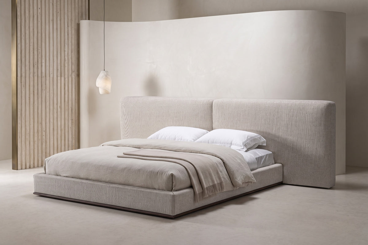 The Lecce Bed with a wide panelled headboard in a calm plaster bedroom