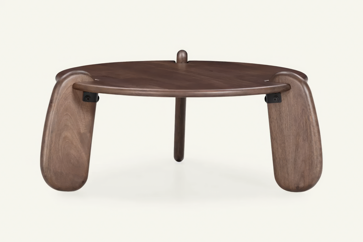 The Lipari Coffee Table in walnut, round mango wood coffee table with sculpted legs, studio view