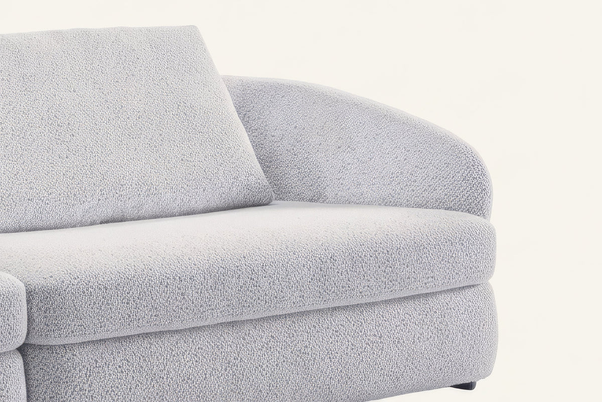 The Livorno Sofa, close-up of the rounded arm and flecked bouclé