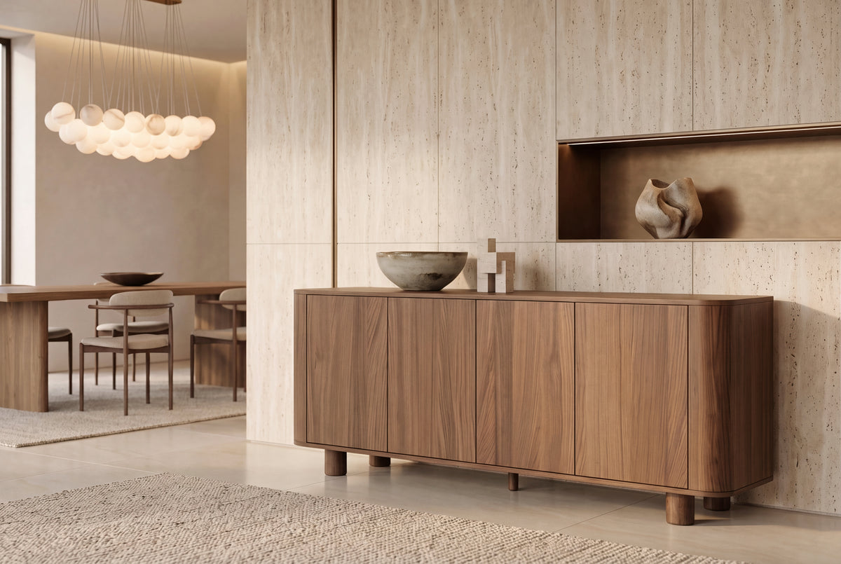 The Menton Sideboard in walnut in a travertine dining room beneath an alabaster sphere chandelier
