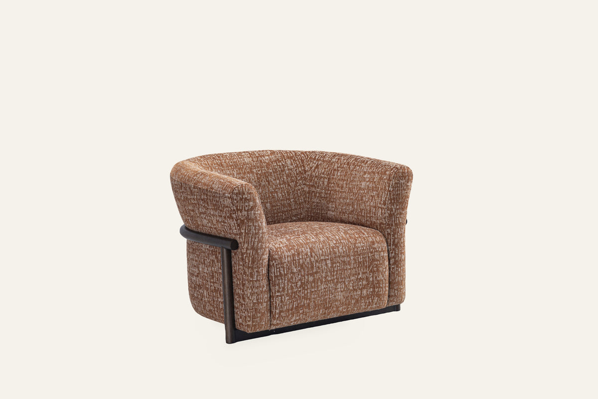 The Modica Armchair in rust, studio view