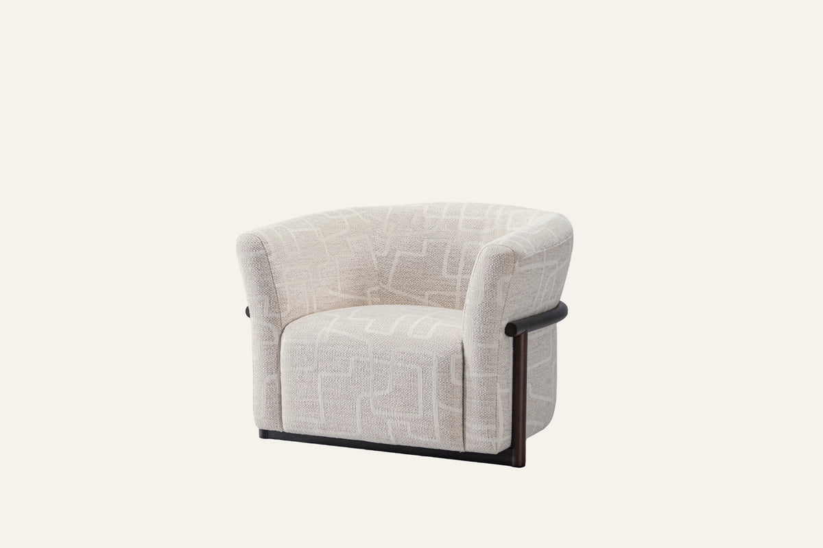 The Modica Armchair in cream, studio view