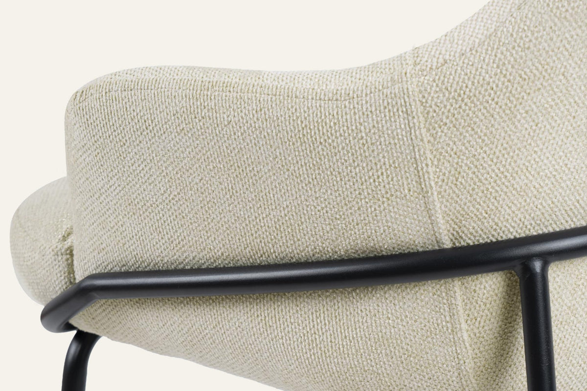 The Moneglia Counter Stool, close-up of the padded arm and black frame