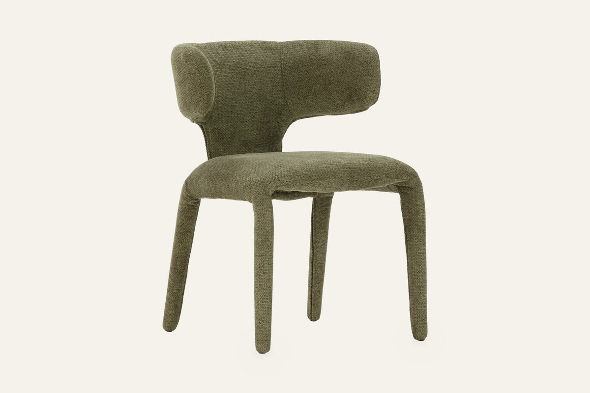 The Nemi Dining Chair in olive, fully upholstered curved dining chair, studio view
