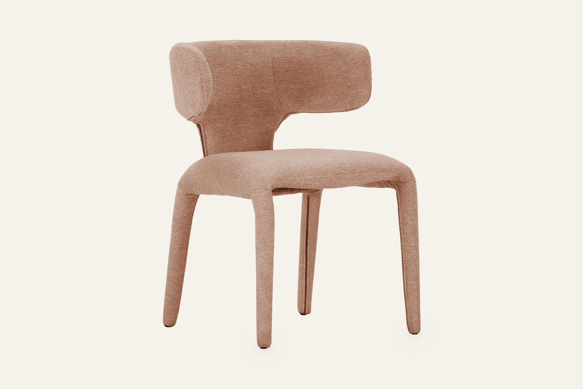 The Nemi Dining Chair in rosed taupe, fully upholstered curved dining chair, studio view