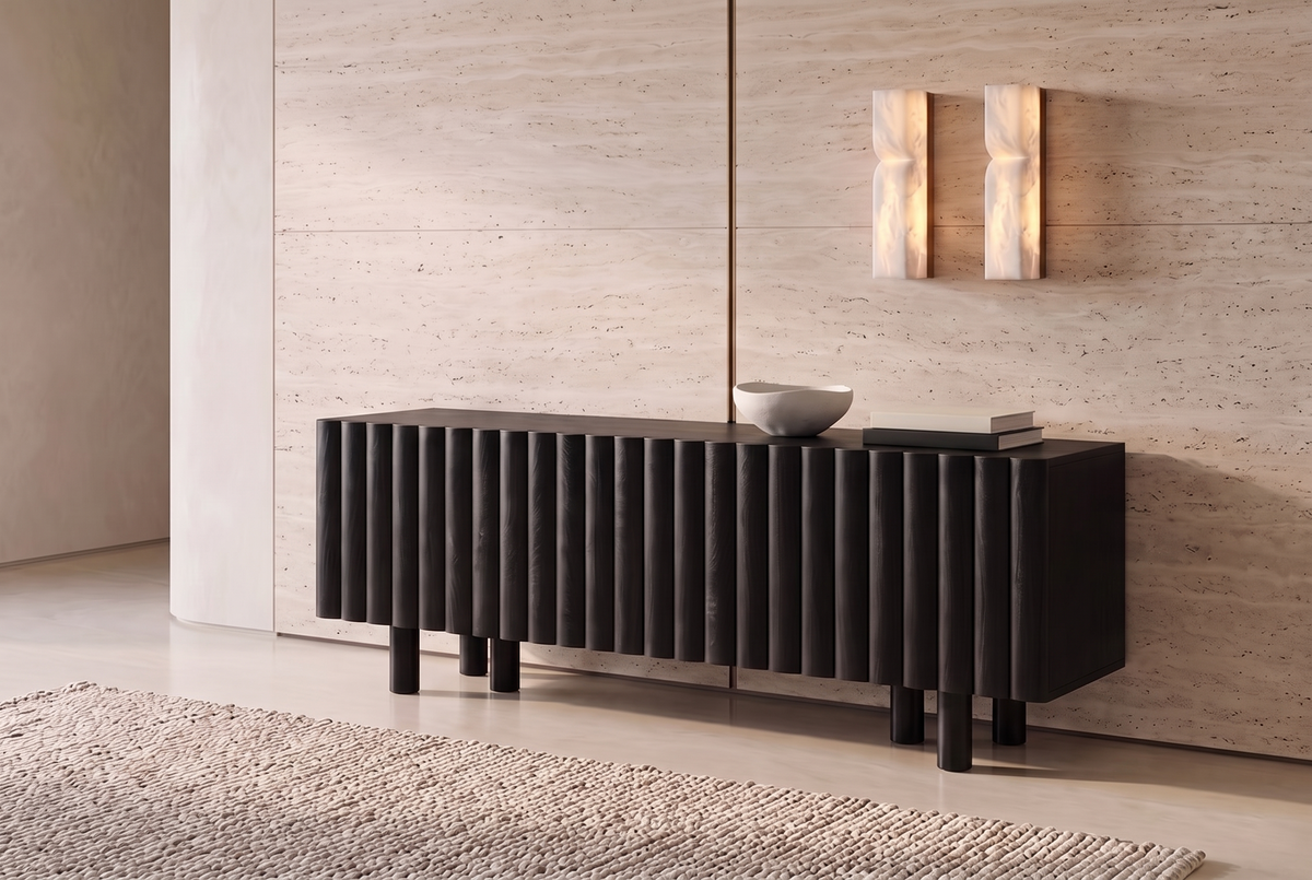 The Noli Fluted TV Unit in black against a travertine wall beneath a pair of alabaster wall lights
