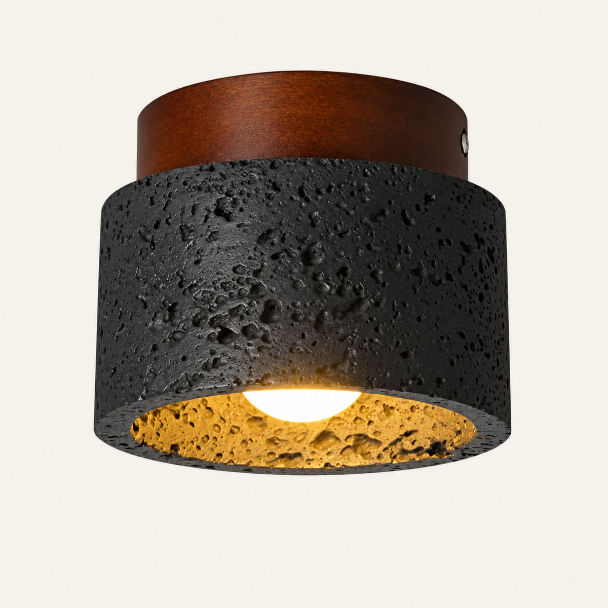 The Notte travertine flush ceiling light, a black stone cylinder with a wood cap, open underneath