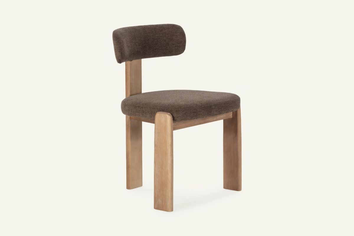 The Orta Dining Chair in brown, upholstered dining chair on a wooden frame, studio view